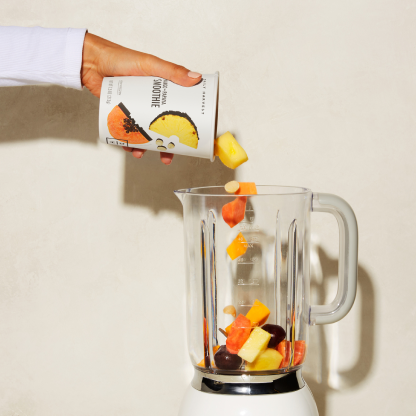 smoothie being poured into a blender.