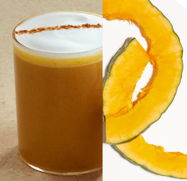Glass of pumpkin spice latte with a slice of pumpkin on a white background