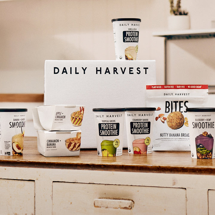 Daily Harvest products including smoothie cups and packaging on a kitchen counter.