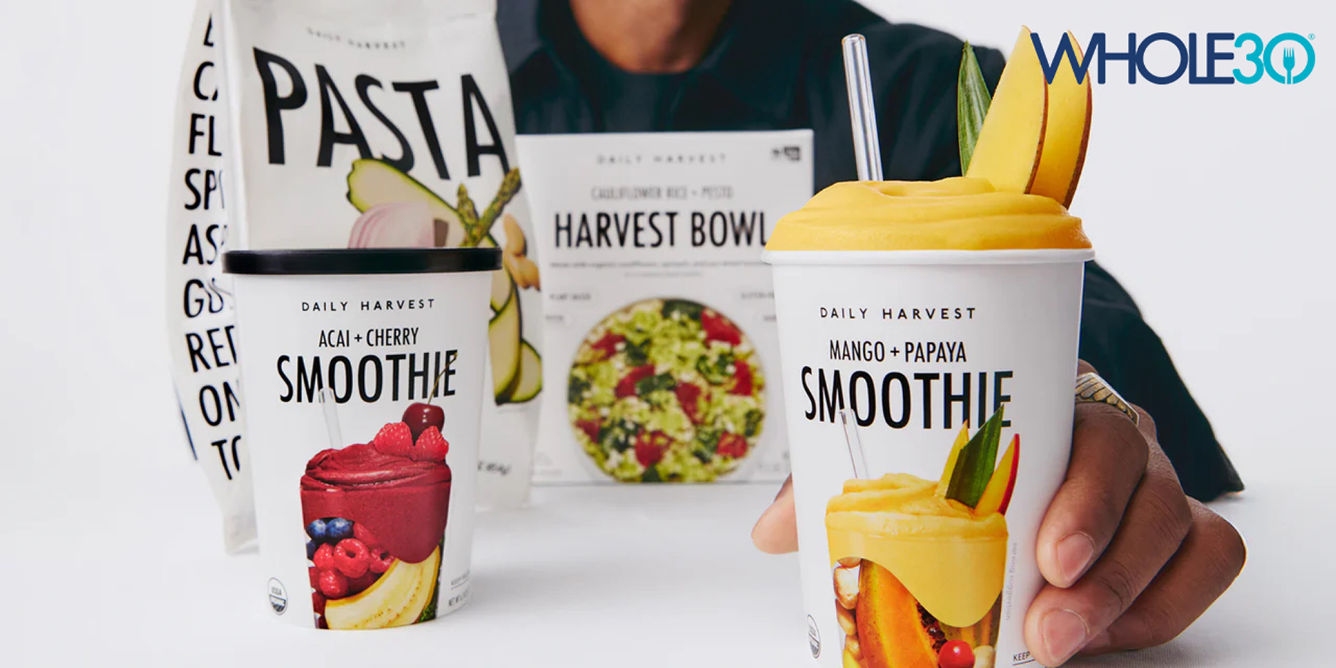 Two Daily Harvest smoothie cups with fruit images and a Whole30 logo on a white background