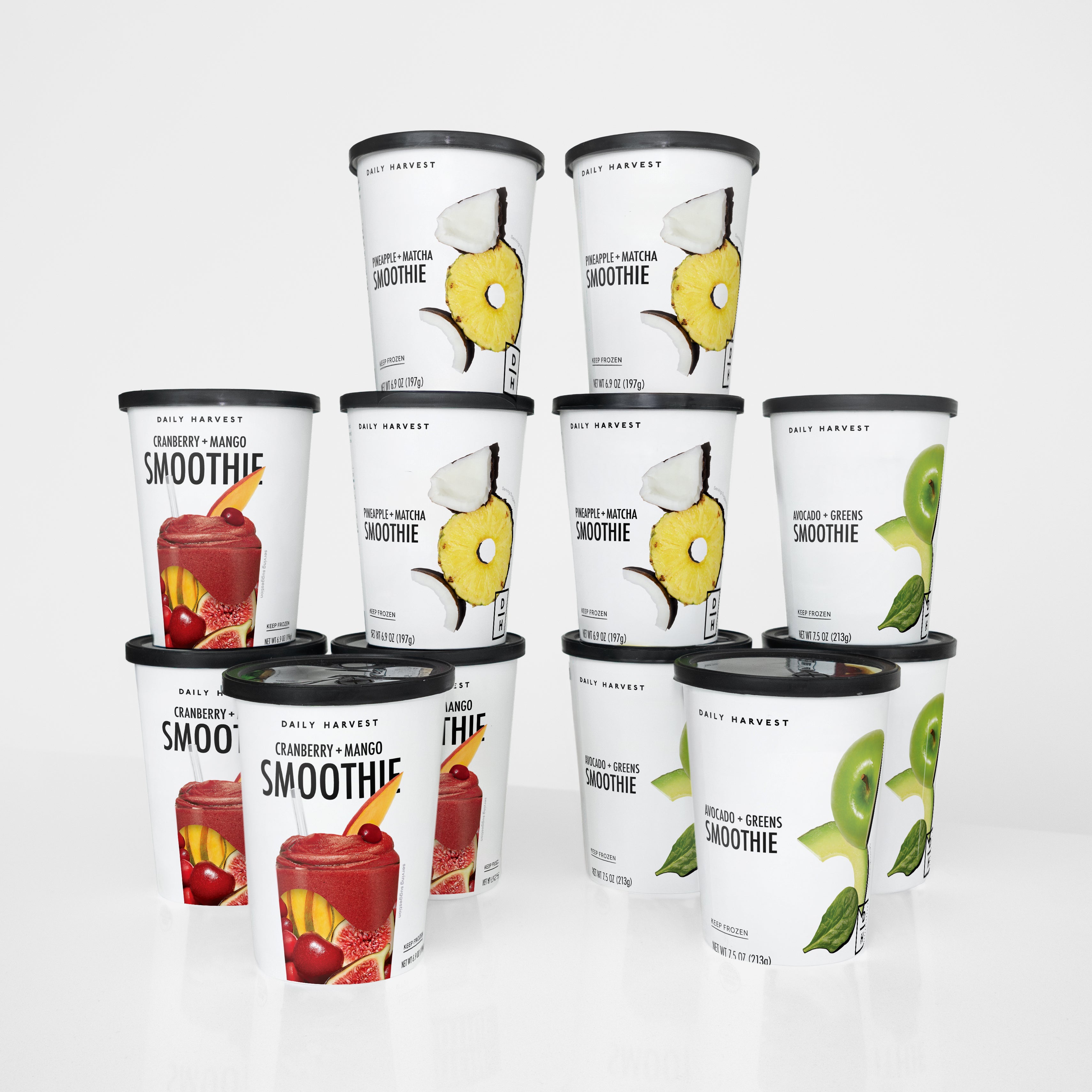 Assorted smoothie containers with different fruit illustrations on a white background