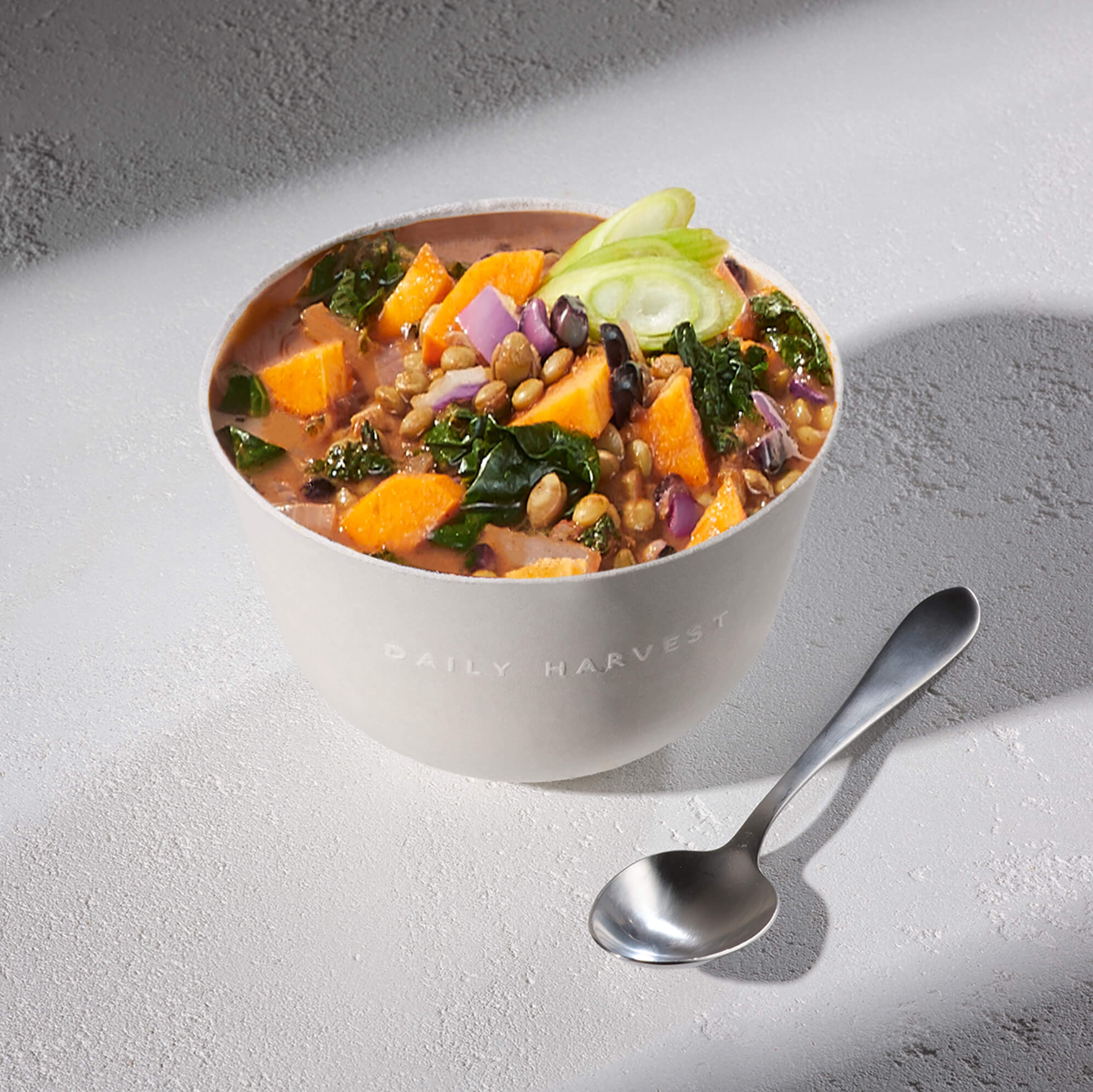 Lifestyle image of Daily Harvest Lentil + Mesquite Chili Soup prepared in a bowl. 