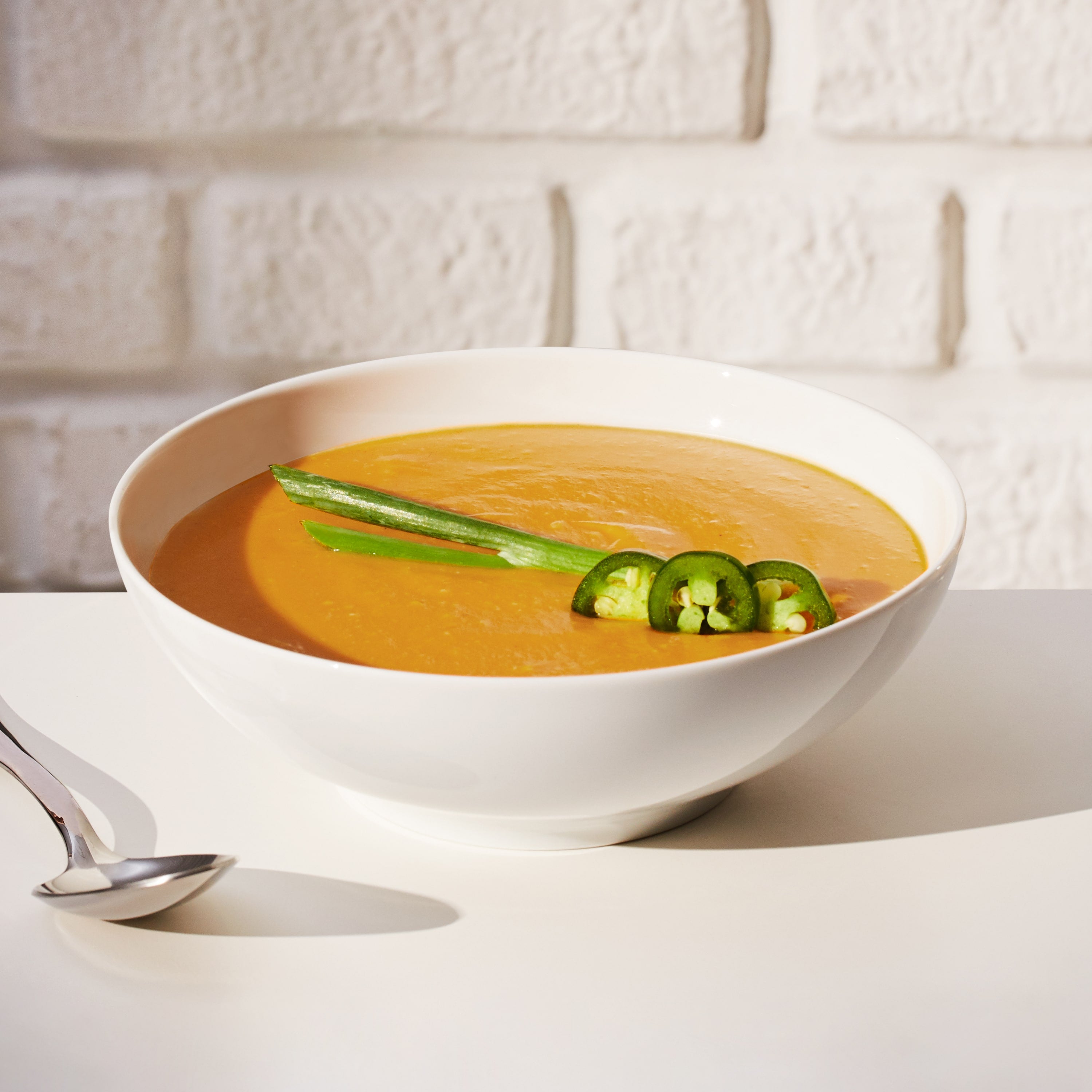 Lifestyle image of a prepared Daily Harvest Sweet Potato + Miso Soup with added garnish.