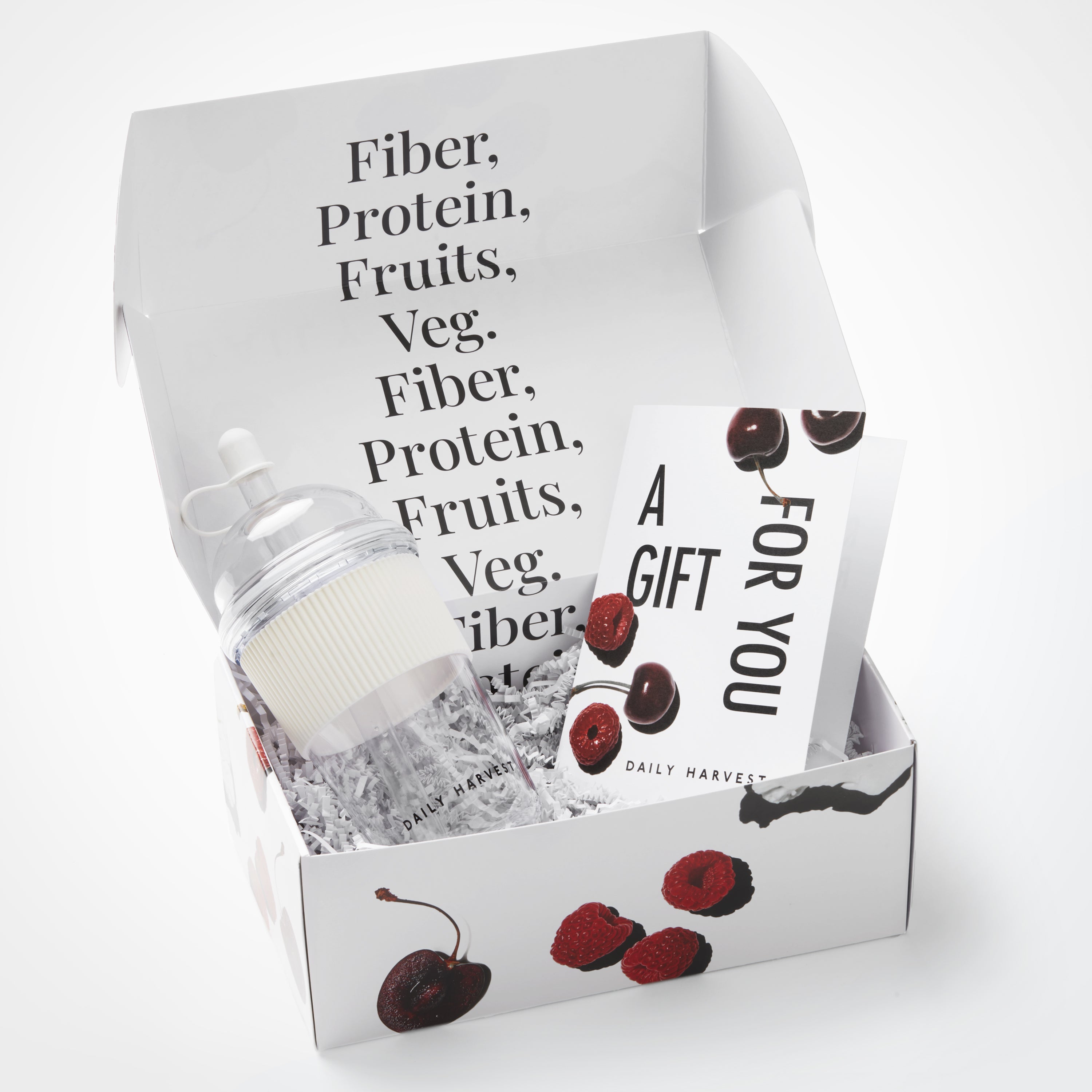 Gift set with a jar labeled 'Fiber, Protein, Fruits, Veg.' and a card in a box with cherry design.