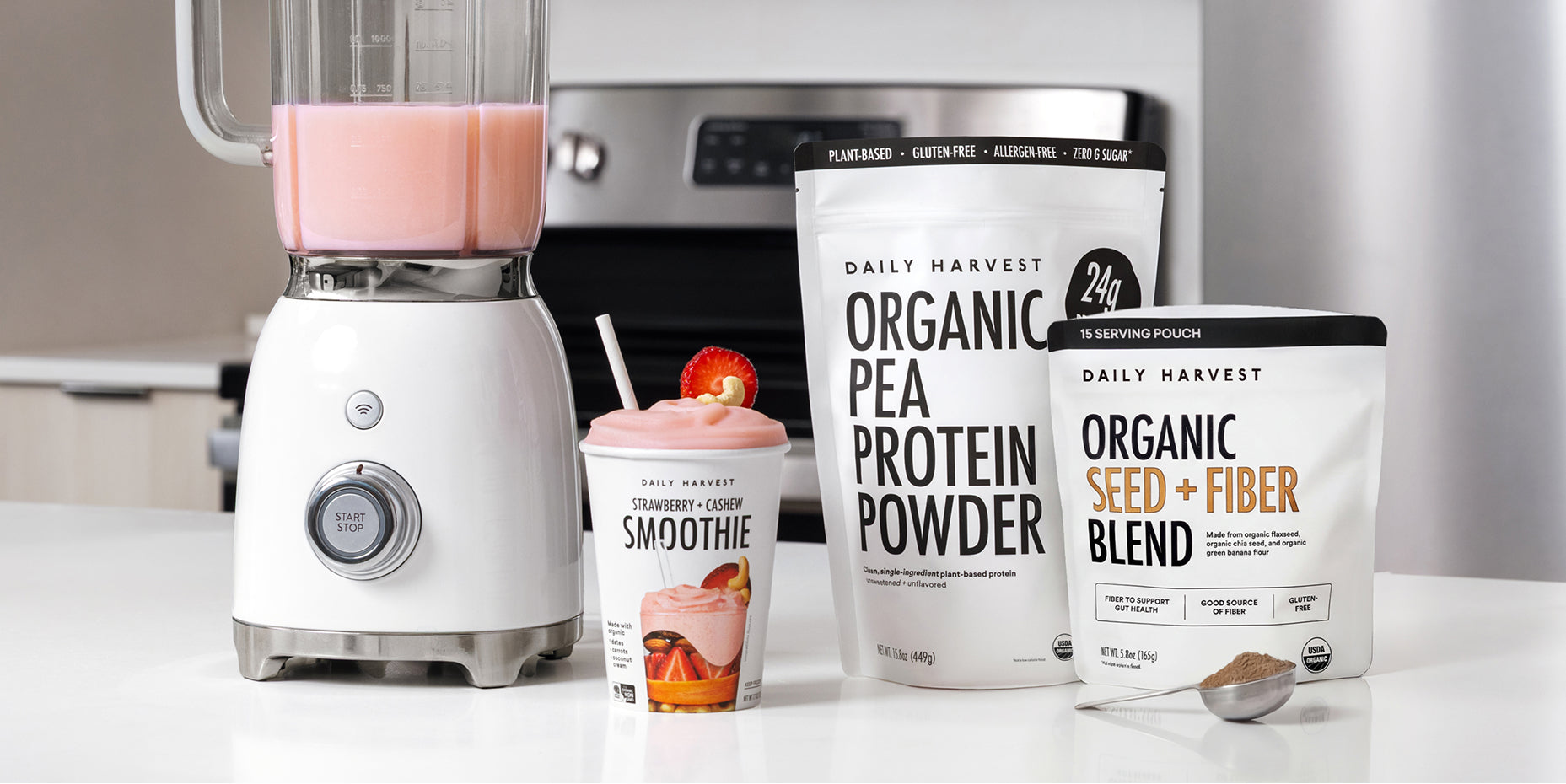 Daily Harvest Harvest Bowl package with prepared meal and Protein Smoothie cup on white table background