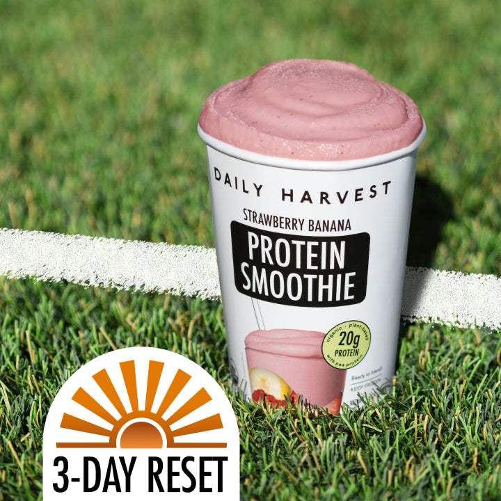 Daily Harvest strawberry banana protein smoothie cup on grass with '3-Day Reset' logo.