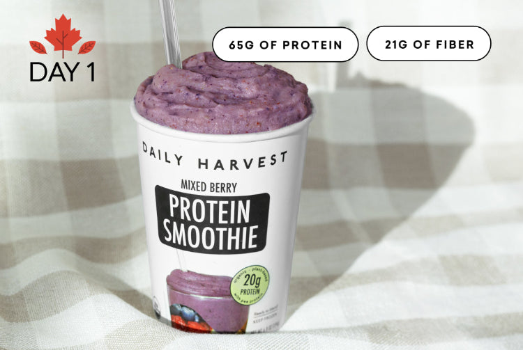 Daily Harvest Mixed Berry Protein Smoothie with nutritional information on a checkered tablecloth.