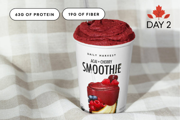 Daily Harvest Acai Cherry Smoothie with nutritional information on a striped fabric background