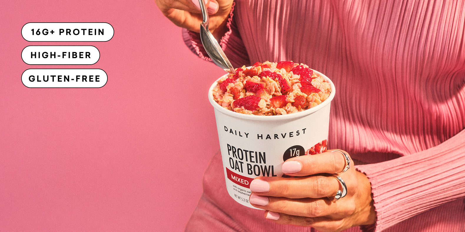 Person holding a Daily Harvest protein oat bowl with text indicating plant-based, gluten-free, and dairy-free ingredients on a pink background.