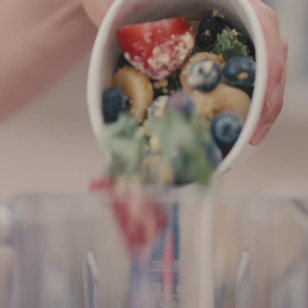 Daily harvest smoothie poured into a blender.