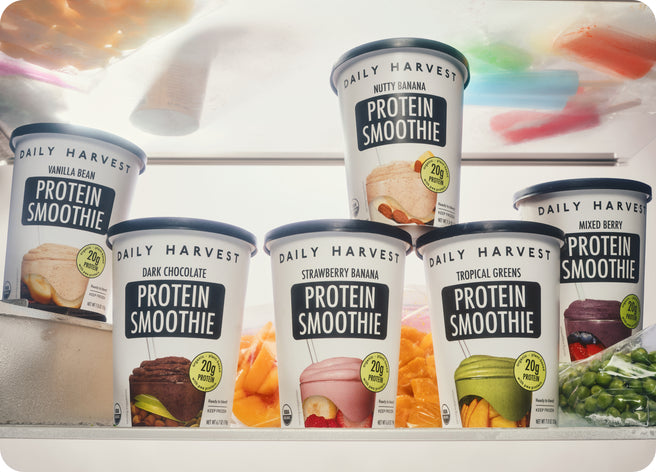 Person holding cremini and asparagus harvest bowl