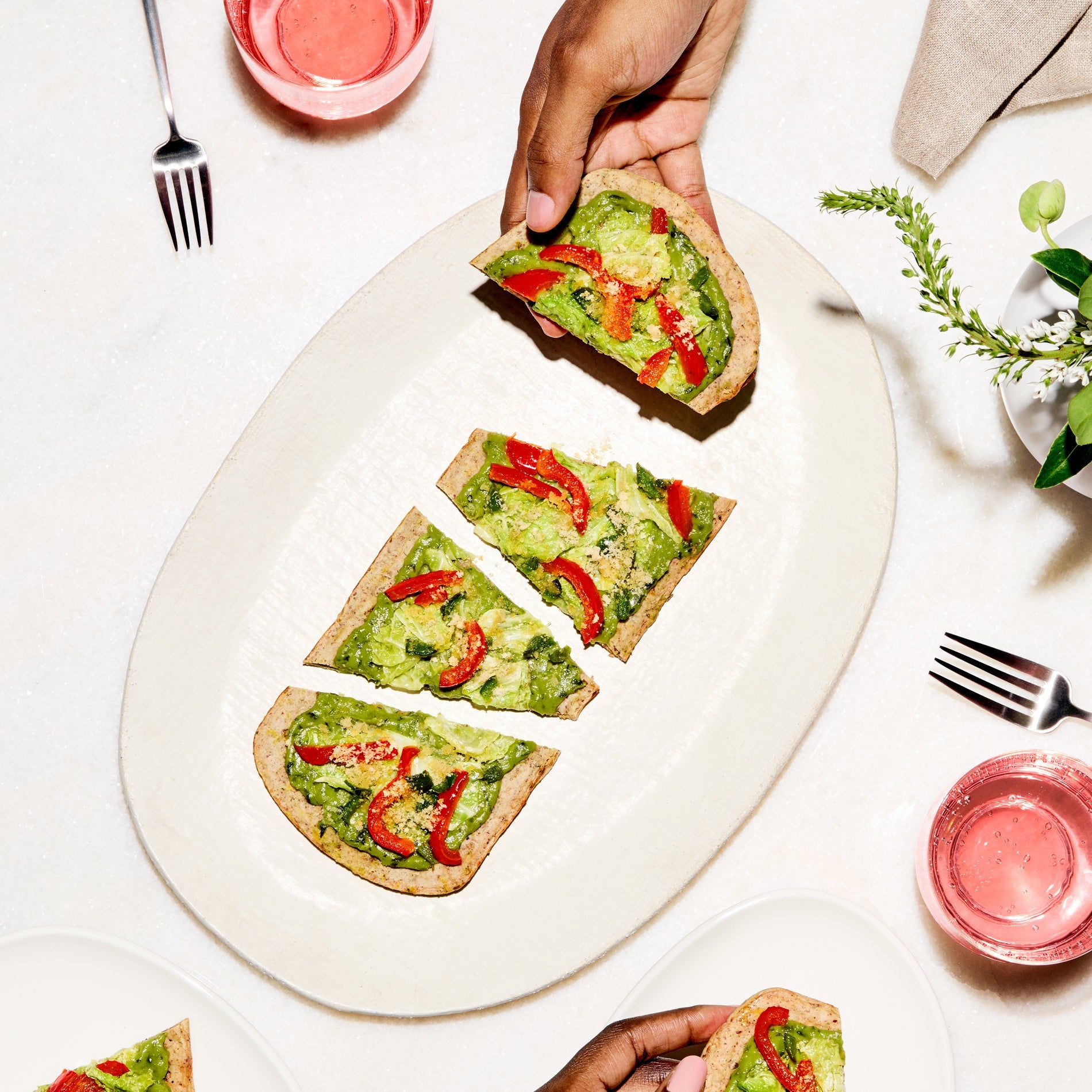 Lifestyle image of Daily Harvest Bell Pepper + Cilantro flatbread prepared.